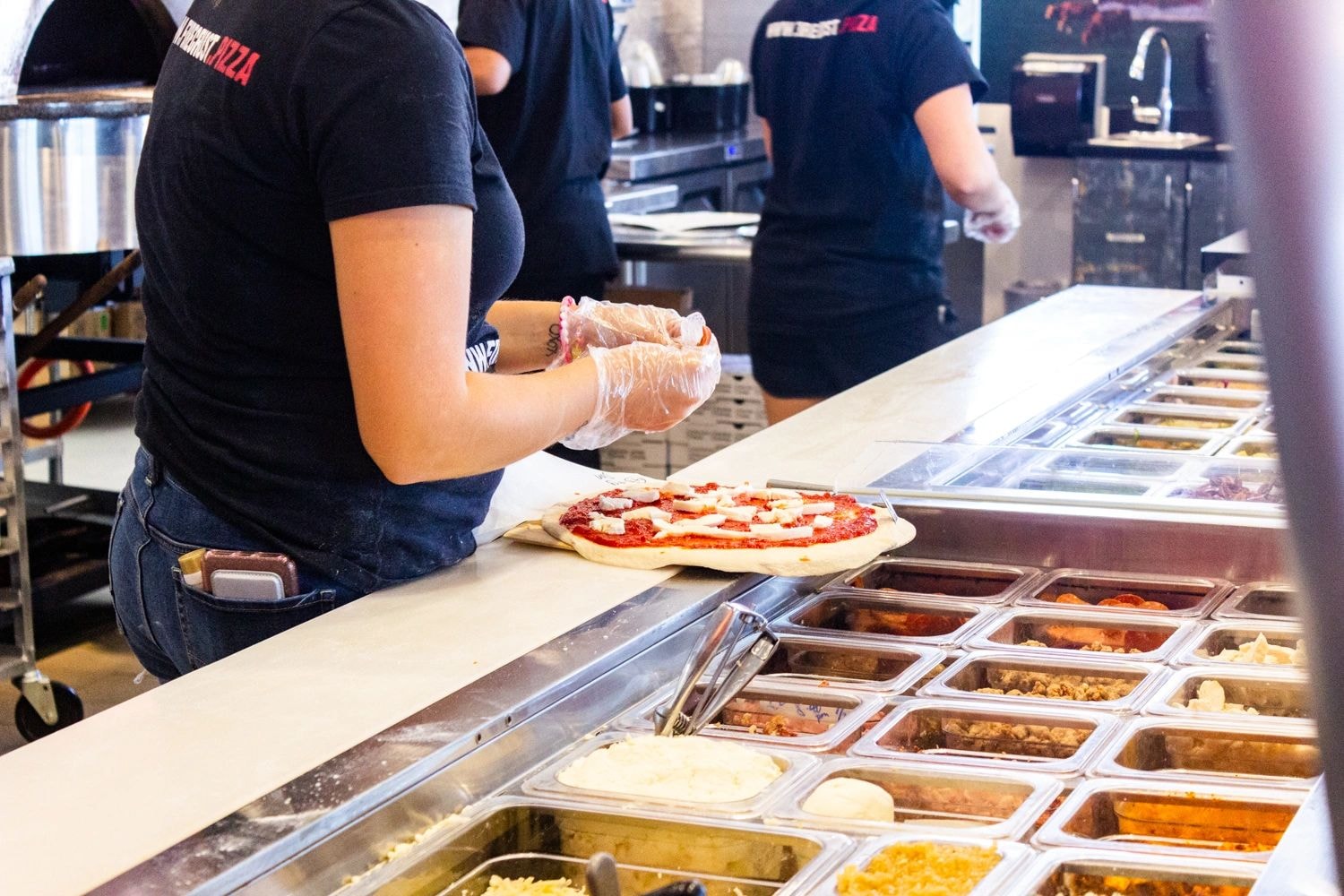 Fire Crust team crafting your pizza
